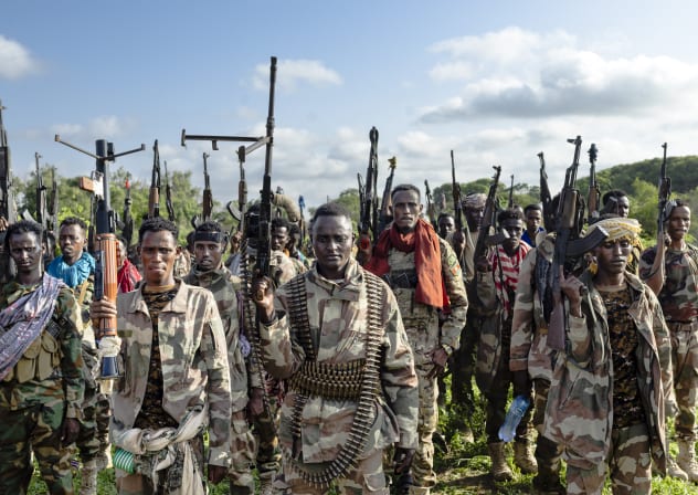 Soldiers of the Somalia National Army (SNA) raise their weapons when they gathered near their camp for a talk from visiting senior officers at Awdheegle, one of several towns recently liberated from the Al-Qaeda-linked terrorists in Somalia's lower-Shabelle region on November, 2025.