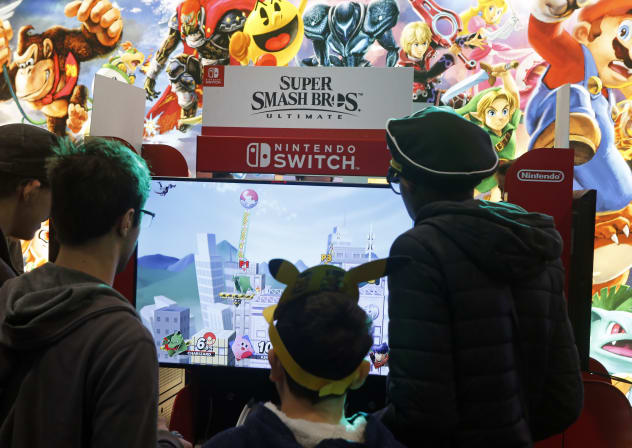 Gamers play the video game 'Super Smash Bros Ultimate' developed by Sora Ltd. and Bandai Namco and published by Nintendo on a Nintendo Switch console during the 'Paris Games Week' on October 27, 2018 in Paris, France.