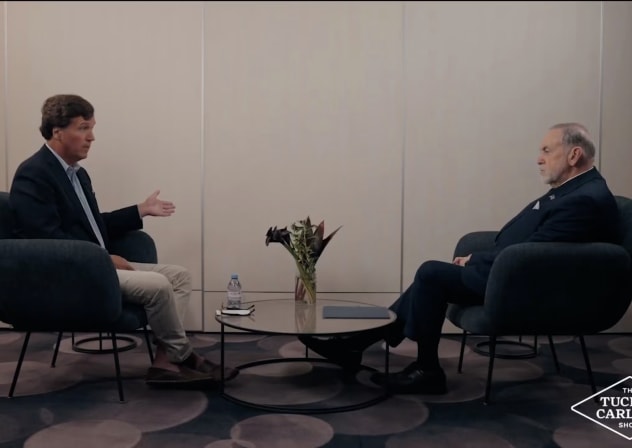 Tucker Carlson and Mike Huckabee speak in a Feb. 19, 2026, interview filmed at Ben Gurion Airport in Israel and released by Carlson online.
