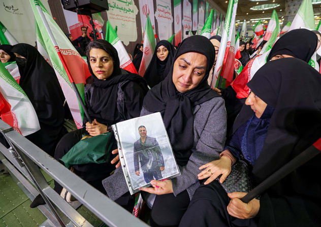 A WOMAN holds a picture of a slain person during a memorial ceremony marking the 40th day of mourning for victims of "terrorism" killed in previous anti-government protests in Iran, at the Tehran Musalla on February 17, 2026.