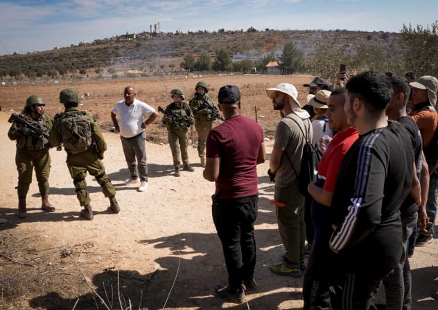 Israeli soldiers disperse Palestinian farmers and left-wing activists preventing them from picking olives during the annual harvest season, in the village of Qusra, in the West Bank, October 29, 2024. 