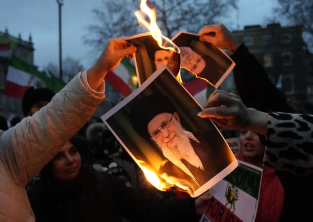 Protestors burn images of Ayatollah Ali Khamenei during a rally held in Solidarity with Iran's Uprising, organised by The national Council of Resistance of Iran, on Whitehall in central London on January 11, 2026.