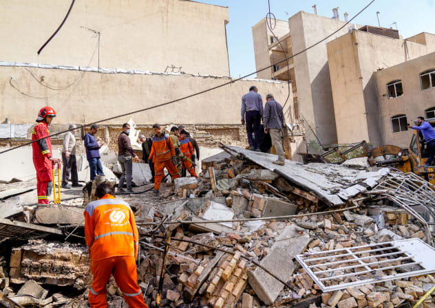  In this picture obtained from Iran's ISNA news agency, rescuers search through the rubble of a collapsed building at the site where a missile hit a neighborhood, in Tehran on February 28, 2026. 