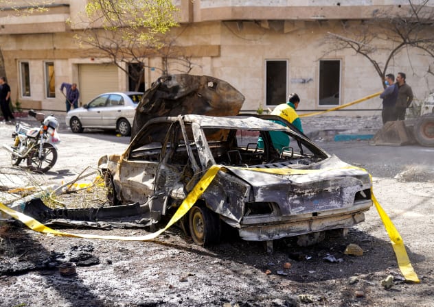 In this picture obtained from Iran's ISNA news agency, yellow tap is rolled out to secure the site where a missile hit a neighborhood, in Tehran on February 28, 2026. 