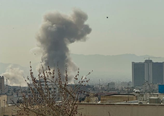 A plume of smoke rises over Tehran after a reported explosion on February 28, 2026, after Israel said it carried out a "preemptive strike" on Iran as sirens sounded in Jerusalem and phone alerts warned of an "extremely serious" threat.