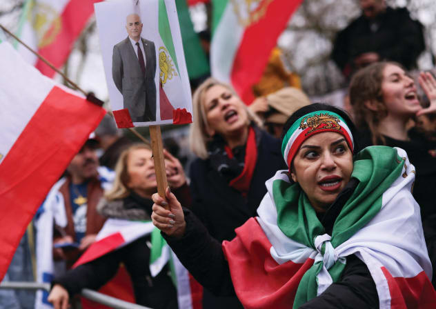 A WOMAN holds a placard with a picture of Reza Pahlavi as people gather outside the Iranian Embassy in London after Iran’s Supreme Leader Ayatollah Ali Khamenei was killed. 