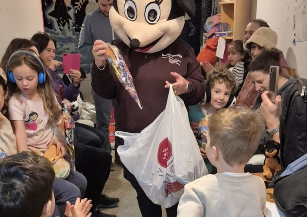A person in a Minnie Mouse costume entertains guests at a Purim party in a bomb shelter in Israel, March 2, 2026.
