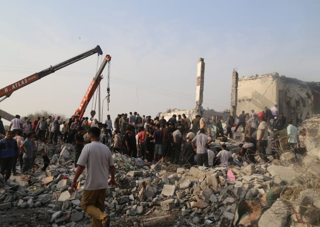 People and rescue forces work following an Israel strike on a school in Minab, Iran, February 28, 2026. 
