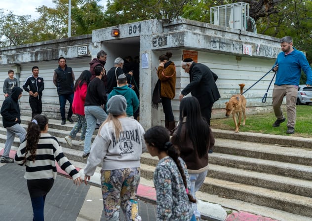 People rush into a public bomb shelter in Tel Aviv amid reports of incoming missiles on February 28.