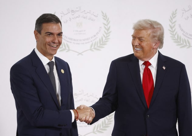 US President Donald Trump and Spain's Prime Minister Pedro Sanchez shake hands as they pose for a photo in Sharm el-Sheikh, Egypt, October 13, 2025
