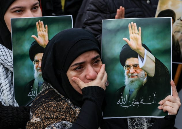 A woman reacts as she holds a placard with an image of Iranian slain Supreme Leader Ayatollah Ali Khamenei, in Beirut, Lebanon, March 1, 2026