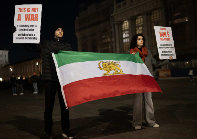 Anti-Iranian regime protesters hold Iranian flag before the 1979 revolution with the Lion and Sun emblems, during a gathering in support of the US and Israel attack of Iran and the killing of the Supreme leader Ayatollah Ali Khamenei in Turin on March 3, 2026. 