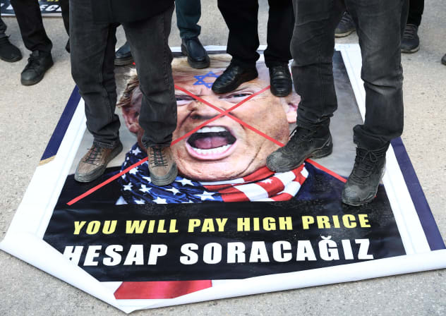 Demonstrators protesting against the attacks on Iran step on a poster of US President Donald Trump, in Turkey, last week. While it’s true that America cannot fight every war, it is certainly obligated to fight against those who have threatened to finish it off, the writer says. 