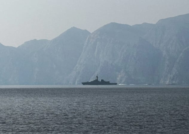 A navy vessel is seen sailing in the Strait of Hormuz, a vital waterway through which much of the world's oil and gas passes on March 1, 2026.