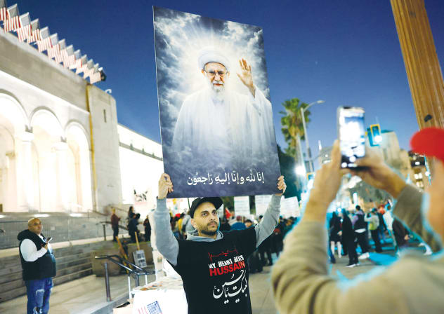 A DEMONSTRATOR holds an image of deceased Iranian Supreme Leader Ayatollah Ali Khamenei during a protest outside City Hall in Los Angeles, last week. The supreme leader thought he was invincible, but he was a lazy thinker, the writer notes.