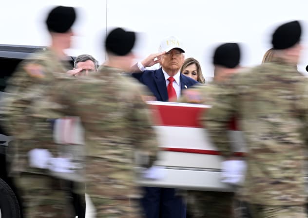 US President Donald Trump salutes as a US Army carry team moves a flagged-draped transfer case containing the remains of Sgt. Declan J. Coady at Dover Air Force Base on March 07, 2026 in Dover, Delaware.