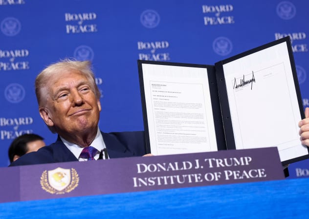 US President Donald Trump holds a signed resolution, during the inaugural Board of Peace meeting at the US Institute of Peace in Washington, February 19, 2026.