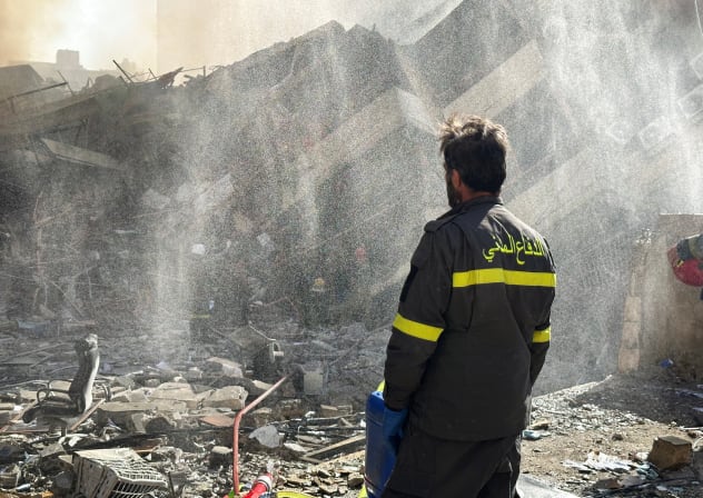 A member of the Lebanese Civil Defense inspects a damaged building after an Israeli strike on Beirut's southern suburbs, following renewed hostilities between Hezbollah and Israel amid the US-Israeli conflict with Iran, Lebanon, March 9, 2026. 