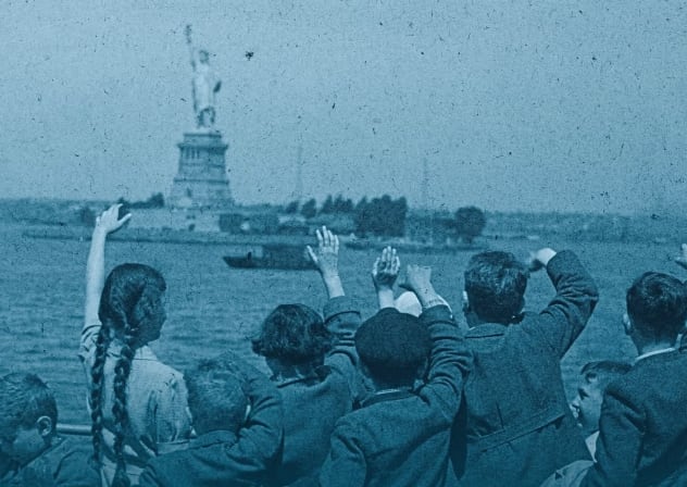 A group of young Austrian immigrants wave to the Statue of Liberty upon their arrival in America aboard the S.S. Harding. The 50 Jewish children, who were greeted by their new adoptive families, were fleeing Nazi persecution in their homeland.