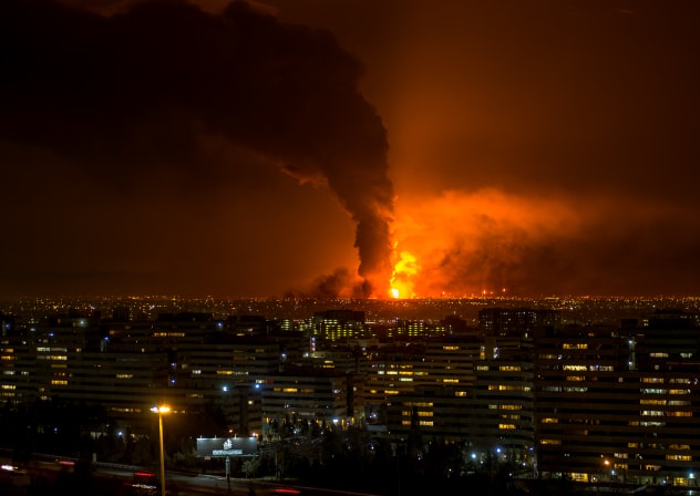 Smoke and flames rise at the site of airstrikes on an oil depot in Tehran on March 7, 2026. 