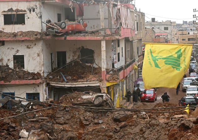 This photograph taken during a media tour organized by the Hezbollah shows a flag of Hezbollah installed on the balcony of a damaged building at Nabi Sheet town after an Israeli military operation in the Bekaa Valley of Lebanon, on March 7, 2026. 