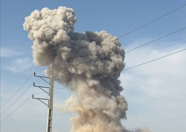 A pillar of smoke and debris rises after a strike on Bushehr, Iran, March 11, 2026.