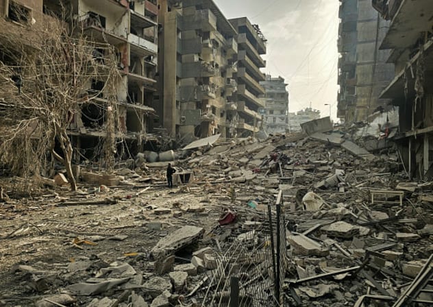 A man looks at the site of overnight Israeli airstrikes in the southern suburbs of Beirut on March 12, 2026.