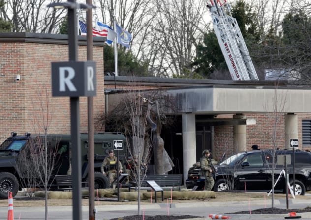 Law enforcement remain on site at the Temple Israel synagogue in West Bloomfield, Michigan, a Detroit suburb, on March 12, 2026, after an assailant drove a vehicle into the building.