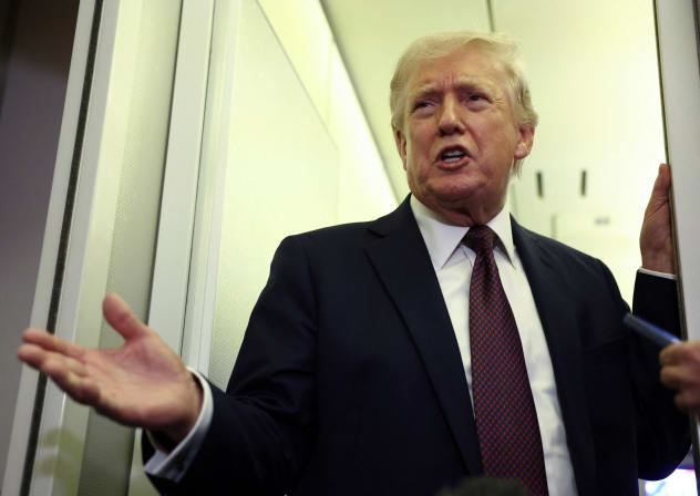US President Donald Trump speaks to reporters aboard Air Force One on a flight back to Washington March 15, 2026.