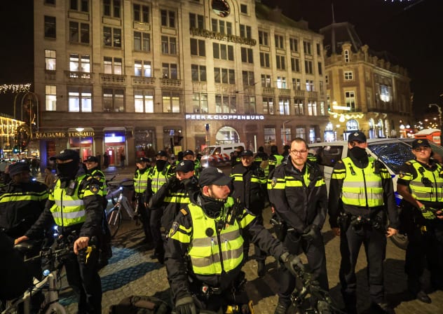 Police arrest individuals who allegedly threw a red substance at an Israeli flag and red smoke bombs in the middle of a demonstration, on December 17, 2025 in Amsterdam, Netherlands.