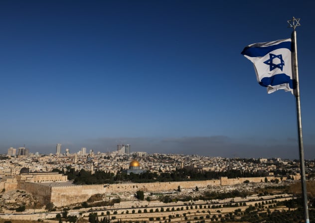 An Israeli flag flies on the Mount of Olives overlooking the Temple Mount and the city skyline in Jerusalem on April 19, 2024.
