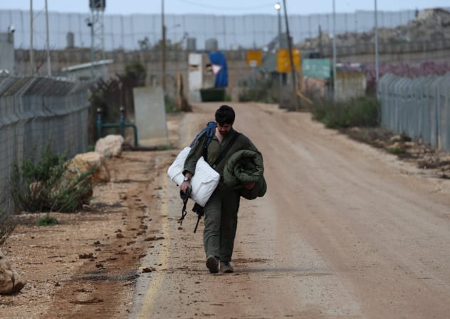 An Israeli soldier walks towards the border wall with Lebanon amid escalation between Hezbollah and Israel and the US-Israeli conflict with Iran, as seen from Israel's border with Lebanon in northern Israel, March 18, 2026. 