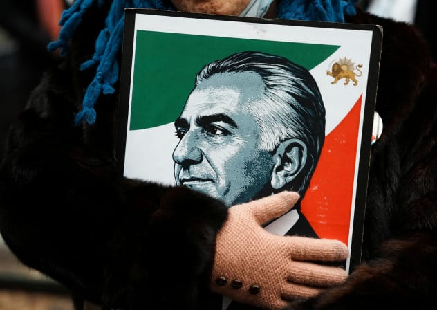 A protestor holds an image of Reza Pahlavi, the exiled son of Iran's last shah, during a demonstration against the Iranian government, in Manhattan, New York City, US, March 15, 2026. 