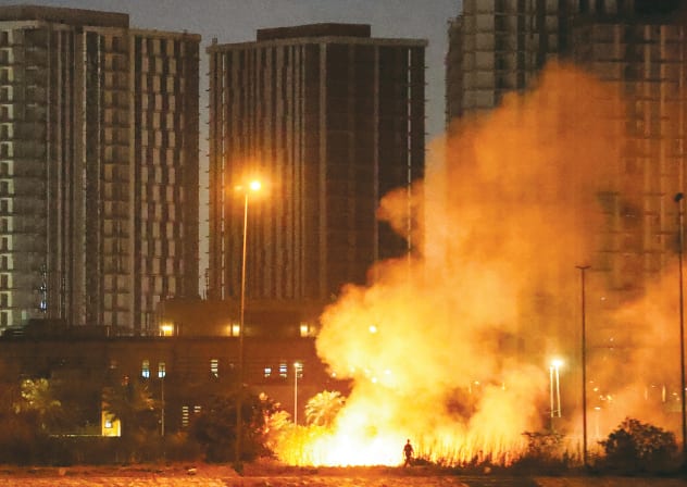 FIRE RAGES outside the grounds of the US Embassy headquarters in Baghdad’s fortified ‘Green Zone’ earlier this week, following a drone and rocket attack according to security officials. Iraq was drawn into the Middle East war after having long been a proxy battleground between the US and Iran.