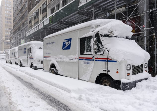 A view of USPS trucks after a day of heavy snowfall on February 23, 2026 in New York City.
