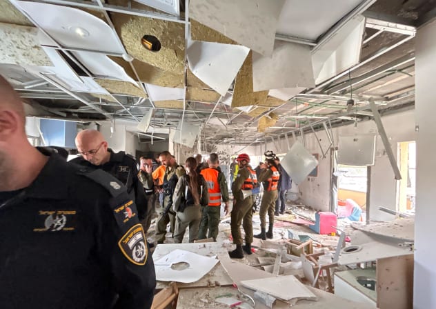 Security forces working at the Kindergarten damaged during an Iranian missile barrage.