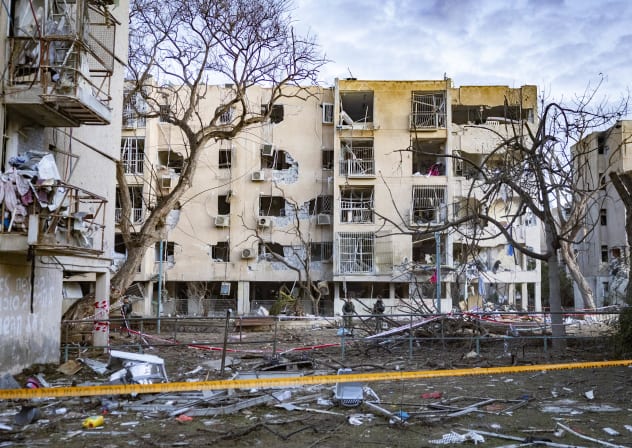 Israeli security and rescue forces at the scene where a missile fired from Iran toward Israel caused damage to residential buildings in the southern Israeli city of Arad, March 22, 2026. 