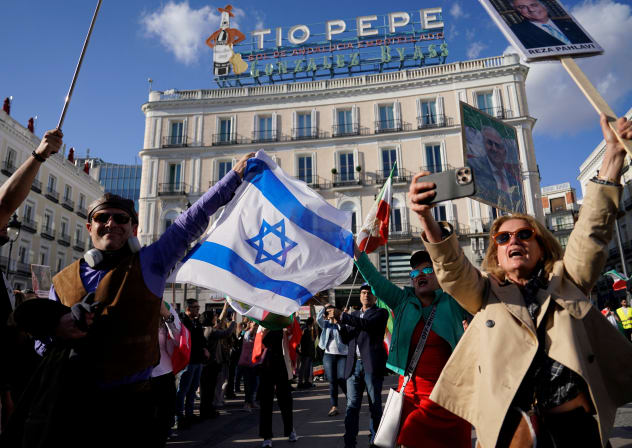 Members of the Iranian diaspora hold an Israeli flag during a protest in Puerta del Sol square in support of the Iranian people, following strikes by the U.S. and Israel against Iran, in Madrid, Spain, February 28, 2026.