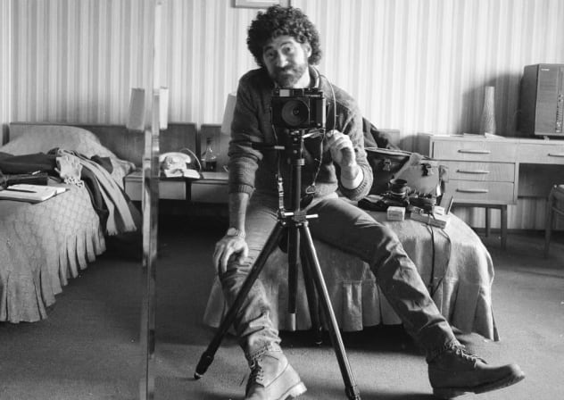 Photographer Edward Serotta takes a self-portrait in a hotel room during his efforts to document Romania in the 1980s.