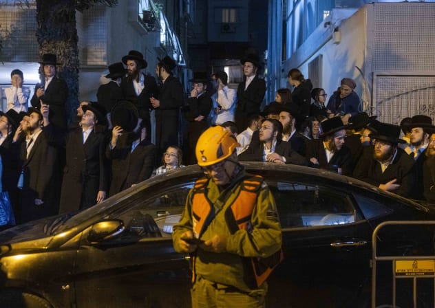 Israeli srcurity and rescue forces inspect the damage at the scene where a missile fired from Iran toward Israel caused damage in Bnei Brak, central Israel, March 24, 2026.