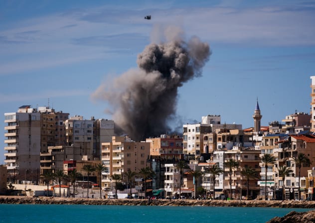  A plume of smoke and a fragment of concrete rise from the site of an Israeli airstrike on the eastern outskirts of Tyre, in southern Lebanon, on March 24, 2026.