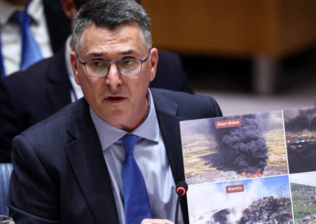Israeli Foreign Minister Gideon Saar shows photos as he speaks during a United Nations Security Council meeting on the Middle East at UN headquarters in New York on February 18, 2026.