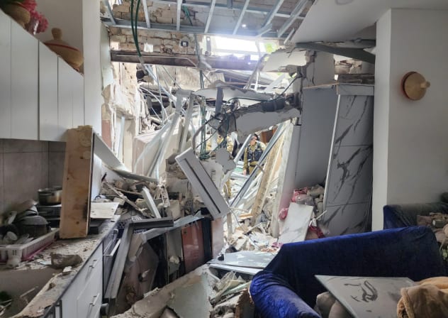 Damage after Iranian missile fragments hit a residence in the Tel Aviv area, March 26, 2026.