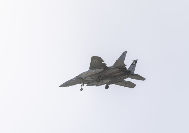 An Israel Air Force F-15 fighter jet flies over the outskirts of Tel Aviv on March 20, 2026.