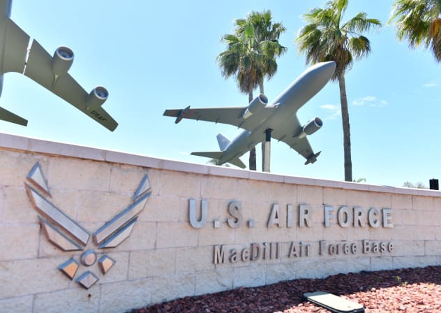 A sign for MacDill Air Force Base is displayed on a concrete wall near the main gate along South Dale Mabry Highway in Tampa, Florida, US March 18, 2026.