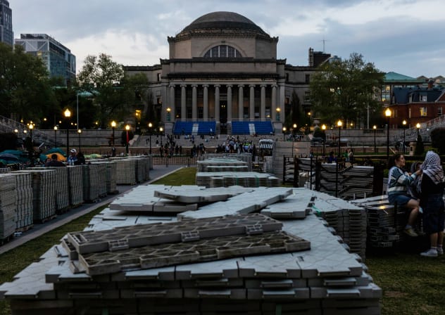 One demonstrator fixes another head scarf outside the pro-Palestine encampment on the Columbia University campus on April 29, 2024 in New York City.