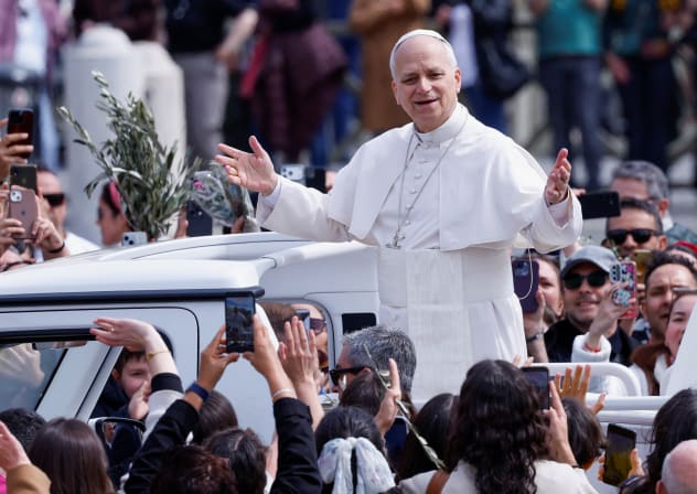 Pope Leo XIV gestures as he leaves after Palm Sunday Mass in Saint Peter's Square at the Vatican, March 29, 2026.