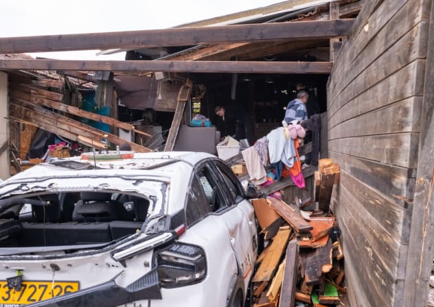 People at the scene where a missile fired from Iran struck Moshav Eshtaol, near the city of Beit Shemesh, causing extensive damage a day earlier, March 29, 2026.