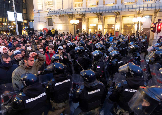 Serbian police officers stand guard as people rally to protest police search of Belgrade's university offices after the accidental death of a student last week, in Belgrade, Serbia, March 31, 2026.