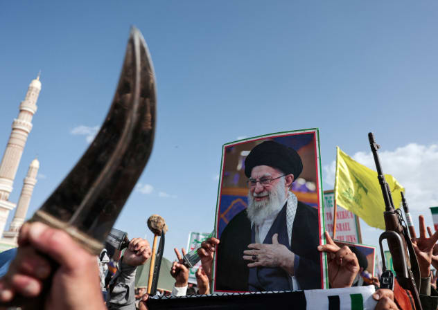 A person holds a poster of the late Supreme Leader of Iran, Ayatollah Ali Khamenei during a demonstration of Houthi supporters in solidarity with Iran, as the U.S.-Israeli conflict with Iran continues, in Sanaa, Yemen, April 3, 2026. 